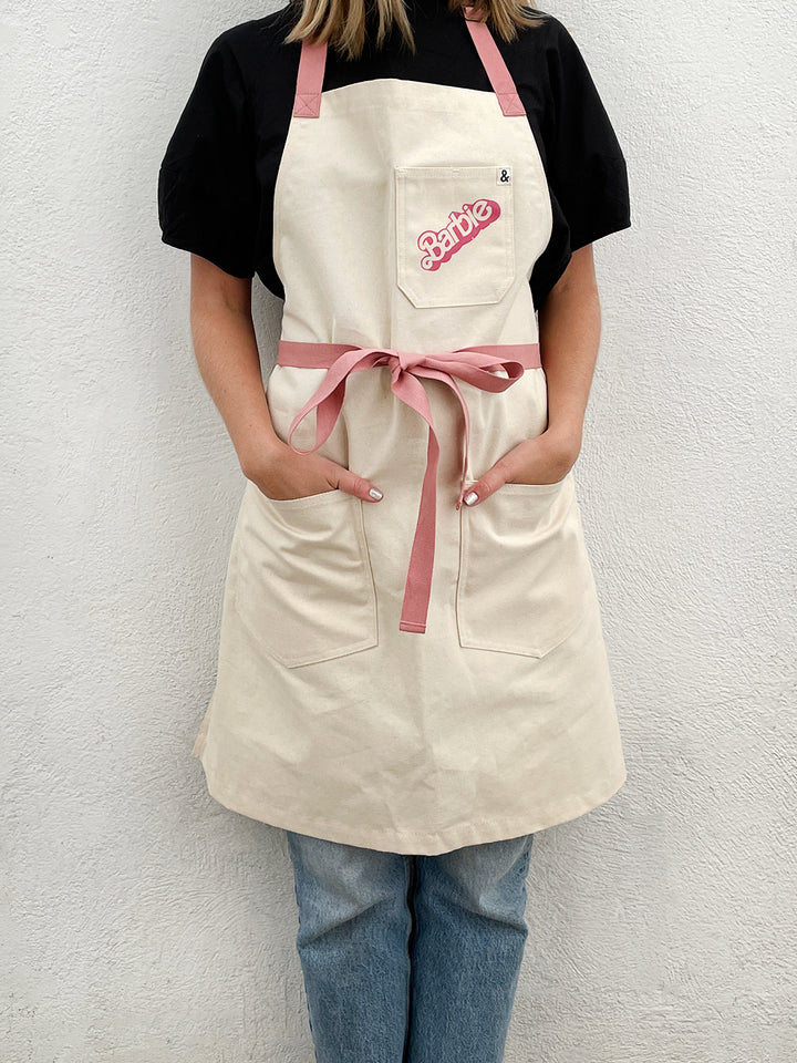 barbie x wallshoppe apron by hedley bennet 80 s logo