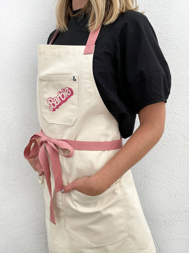 barbie x wallshoppe apron by hedley bennet 80 s logo