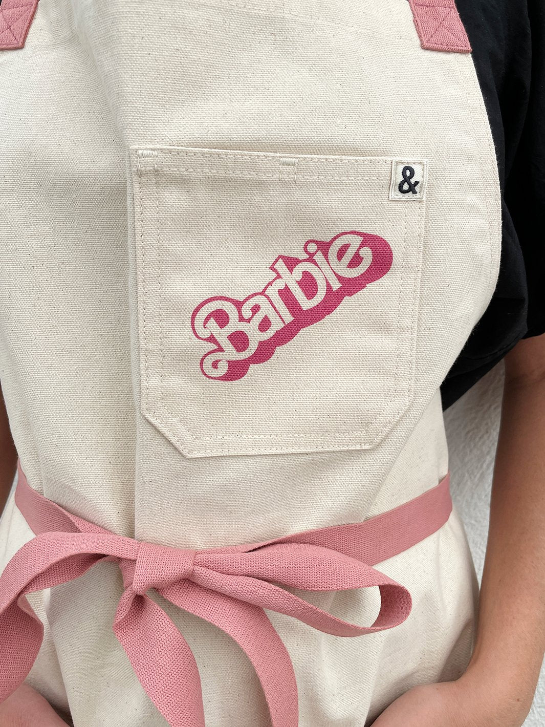 barbie x wallshoppe apron by hedley bennet 80 s logo