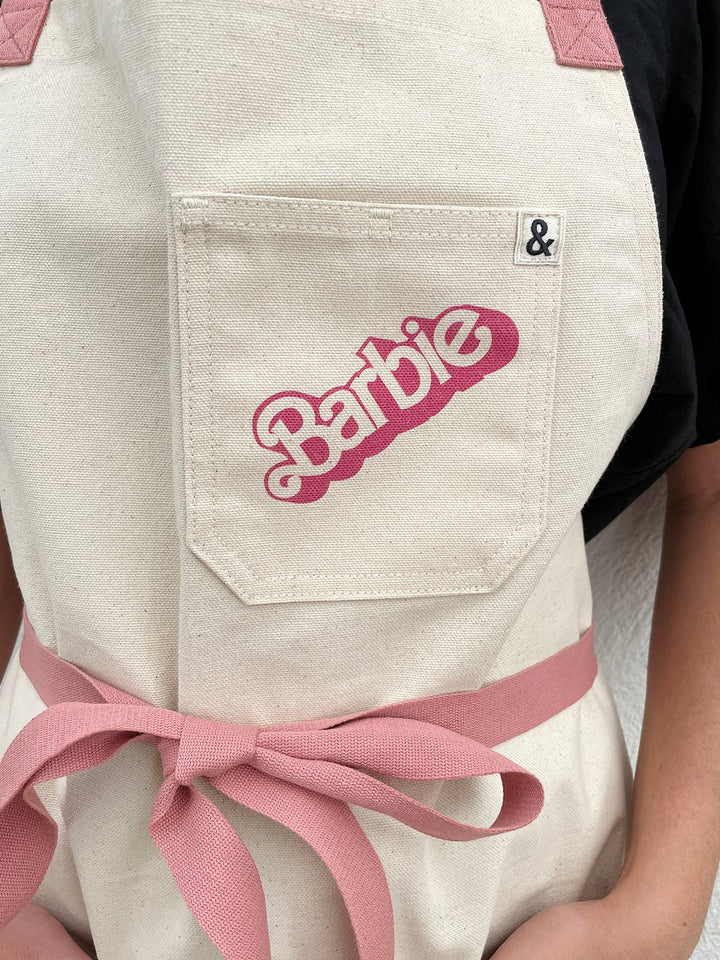 barbie x wallshoppe apron by hedley bennet 80 s logo