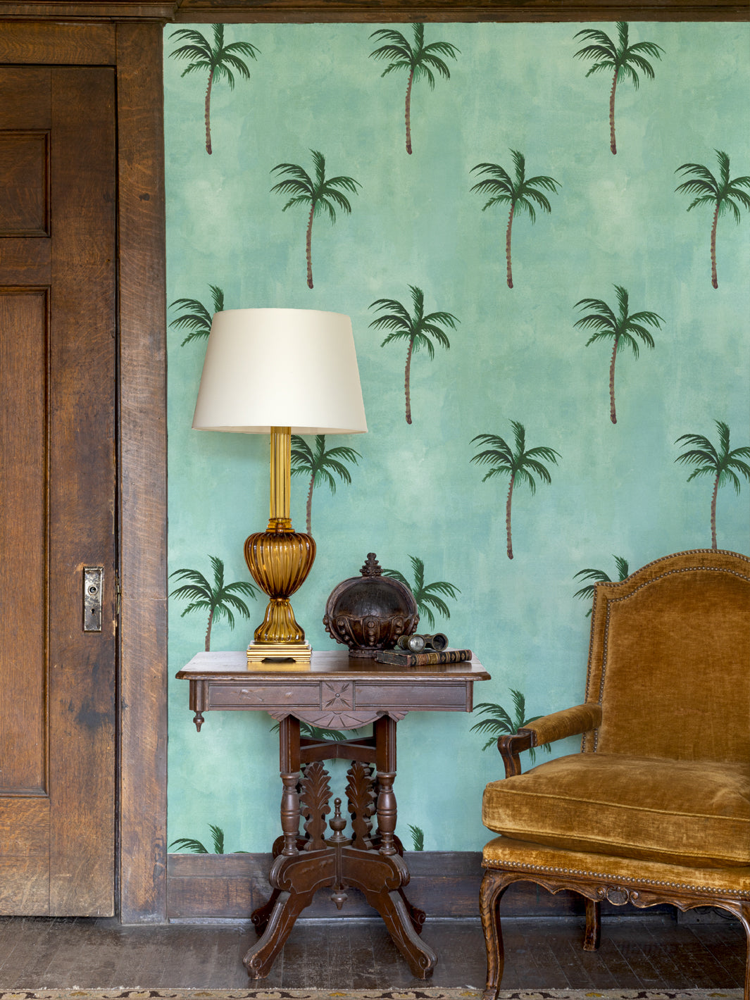 Aqua blue palm wallpaper on a wall with small repeating tree silhouettes