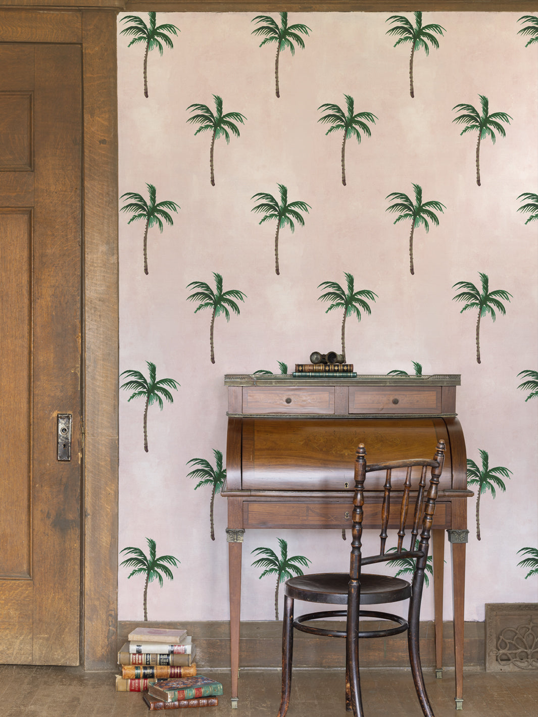Palm tree wallpaper on wall with small repeating green silhouettes