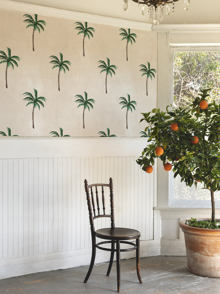 Ivory palm tree wallpaper on wall with repeating green palm motifs