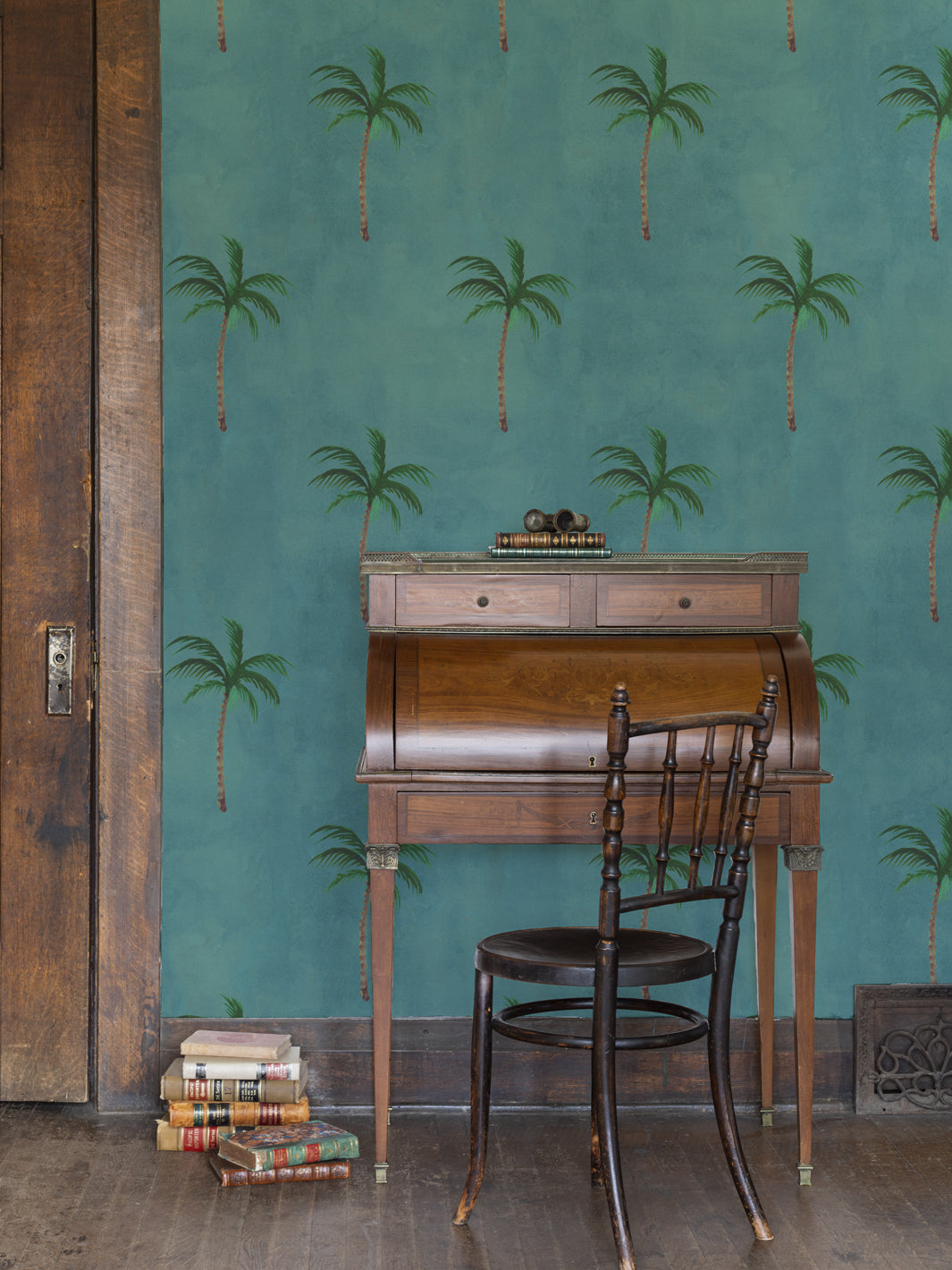 Ocean-blue palm tree wallpaper pattern on wall with occasional room view