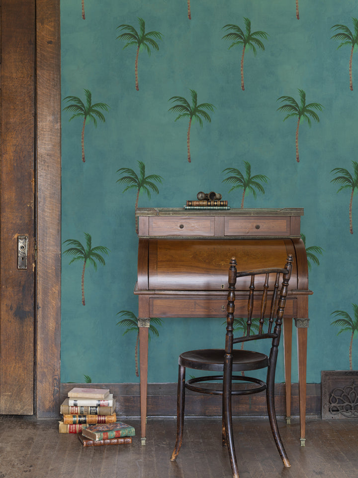 Ocean-blue palm tree wallpaper pattern on wall with occasional room view