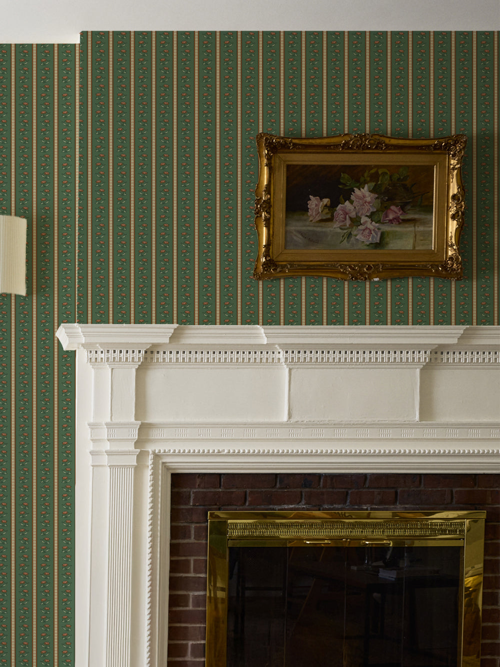 Green lotus stripe wallpaper over a white fireplace mantel with a gilt-framed rose painting