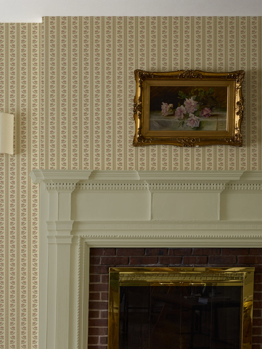 Beige lotus stripe wallpaper above a cream mantel with a gilt-framed rose still life