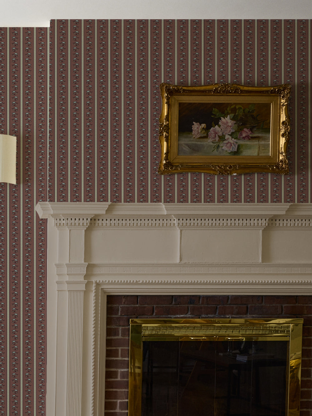 Wine-brown lotus stripe wallpaper above a white mantel with a gilt-framed rose painting