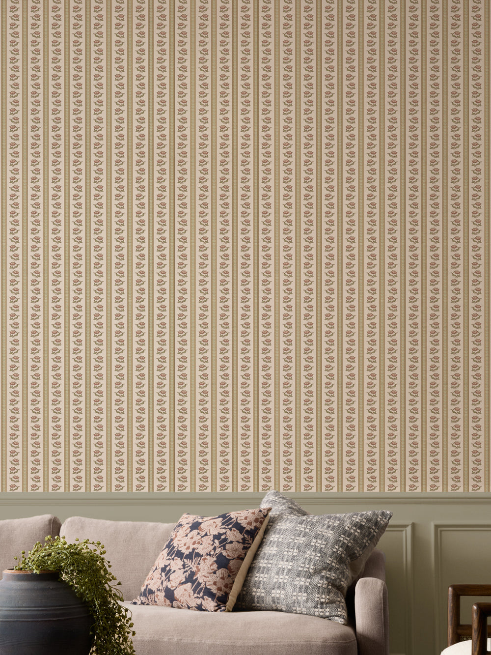 Parchment lotus stripe wallpaper with a greige sofa and a black urn holding a trailing plant