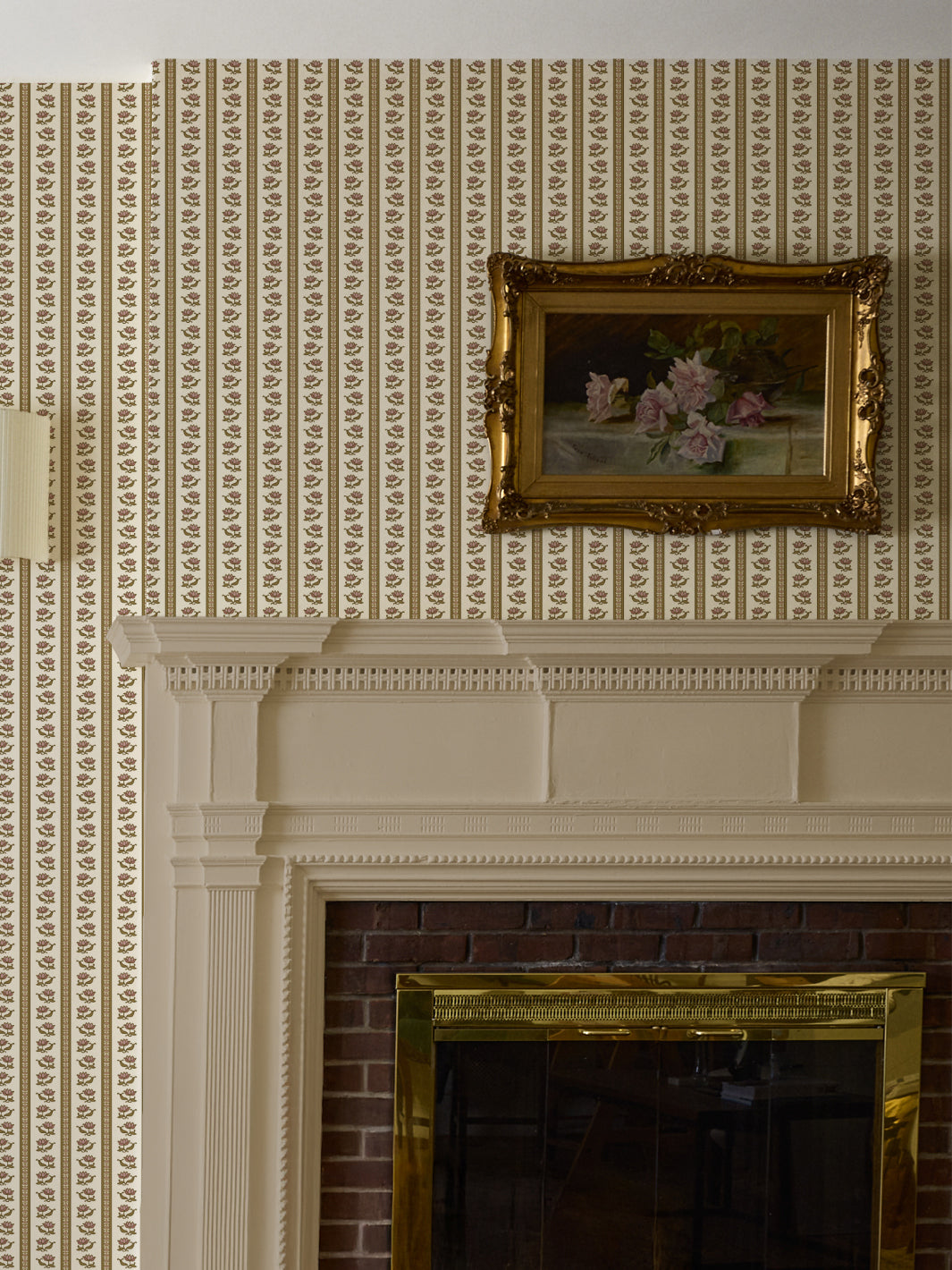 Cream lotus stripe wallpaper above a white mantel with a gilt-framed rose still life