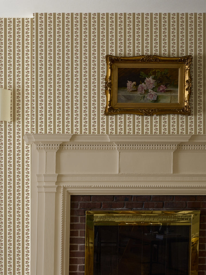 Cream lotus stripe wallpaper above a white mantel with a gilt-framed rose still life