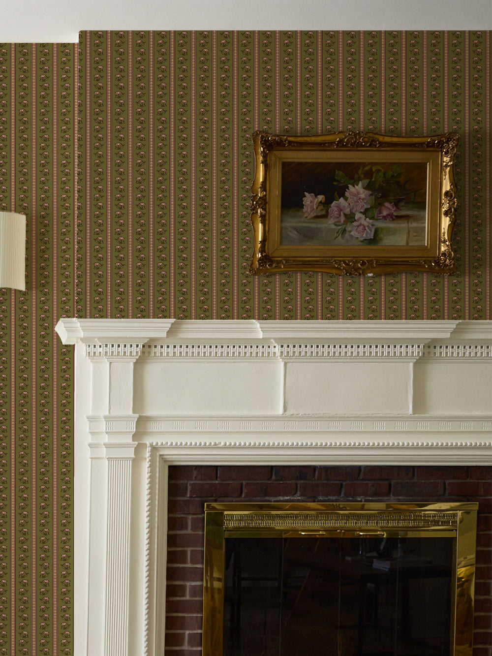 Olive lotus stripe wallpaper above a white fireplace mantel with a gilt-framed rose painting