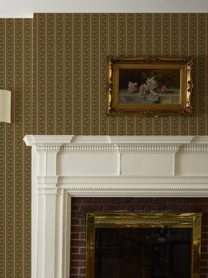 Olive lotus stripe wallpaper above a white fireplace mantel with a gilt-framed rose painting