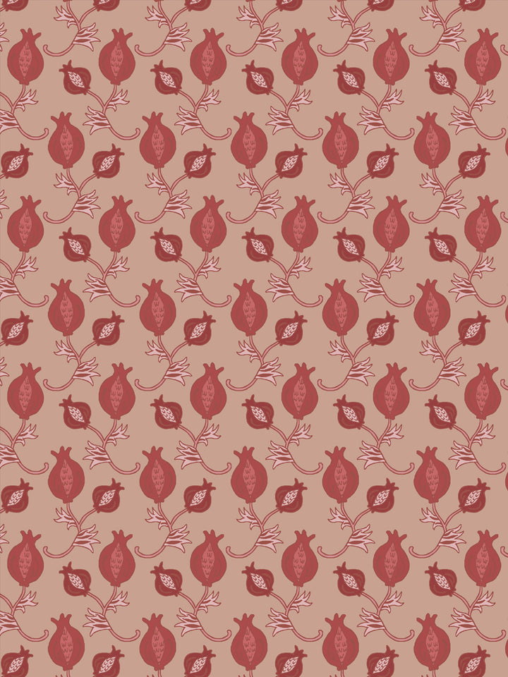 Close crop of brick red pomegranate motifs on warm blush clay pink