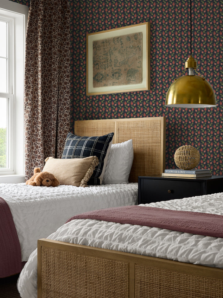 Cane bed with a plaid cushion and mauve throw, black nightstand and brass pendant lamp