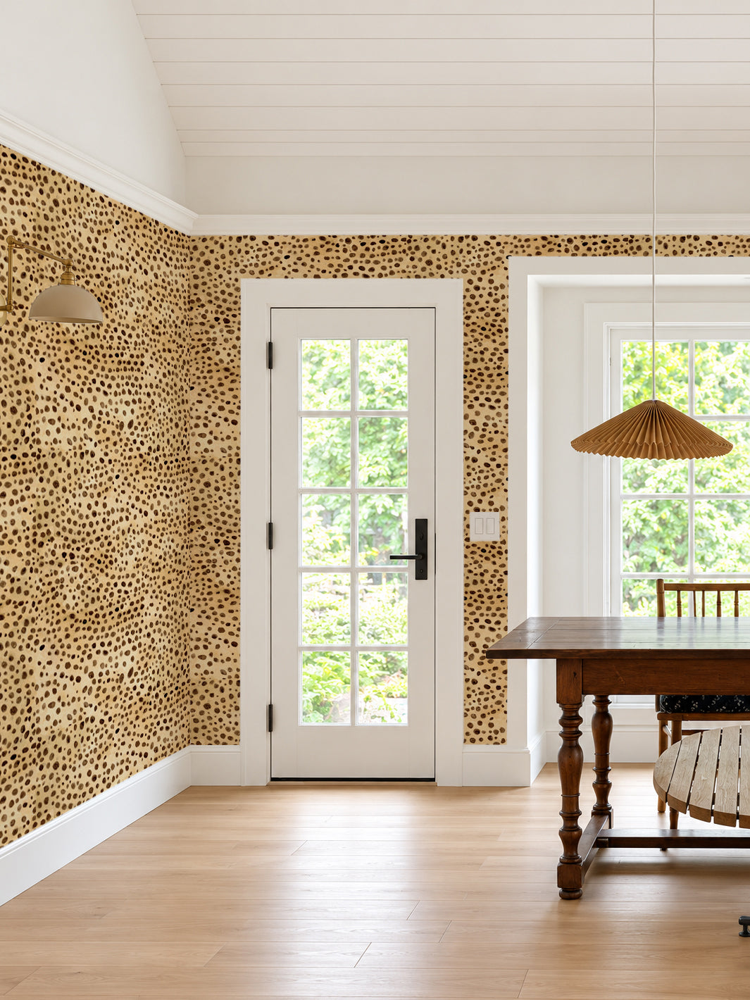Cheetah print wallpaper with multi-colored spots covering an accent wall