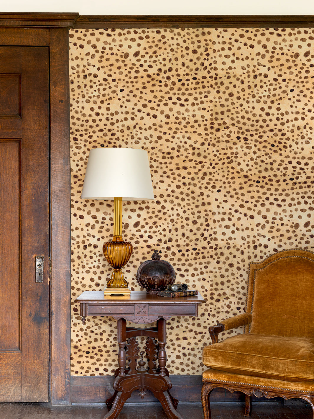 Cheetah print wallpaper on a wall with tan and dark brown spots