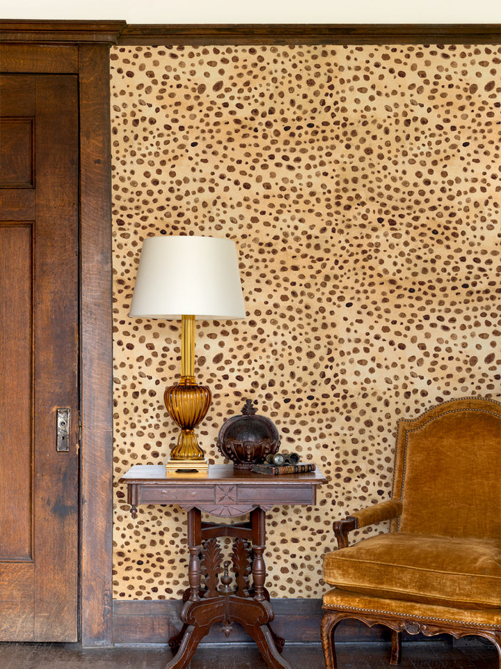 Cheetah print wallpaper on a wall with tan and dark brown spots