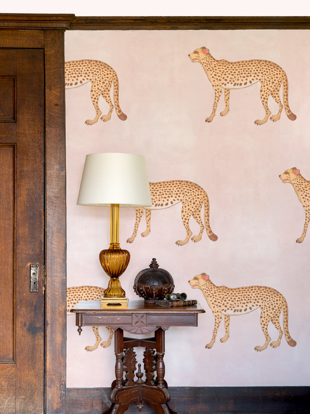 Blush wallpaper featuring multiple illustrated cheetahs with pink accents and dark spots