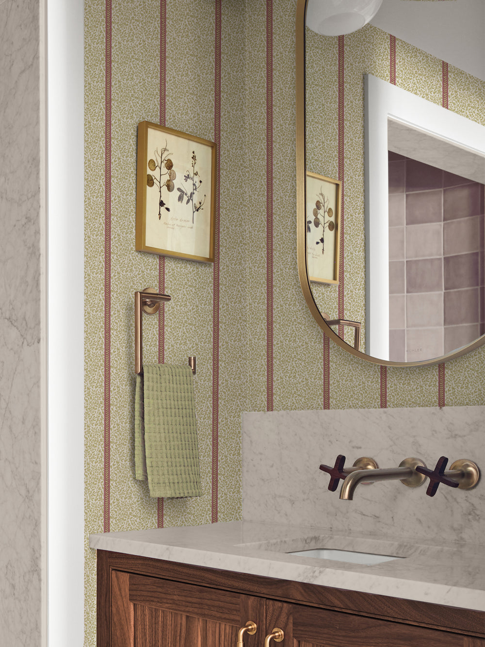 Powder room in olive and rose vine wallpaper with walnut vanity, marble counter and brass faucet