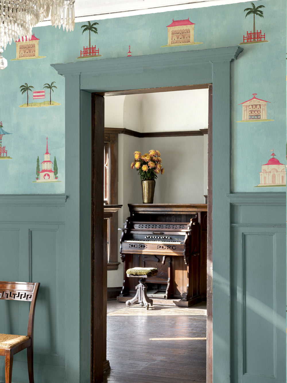Blue patterned wallpaper on walls around an open doorway, with illustrated towers