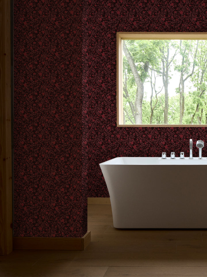 White freestanding tub with chrome faucet by a wood-framed window, walls in dark red pomegranate paper