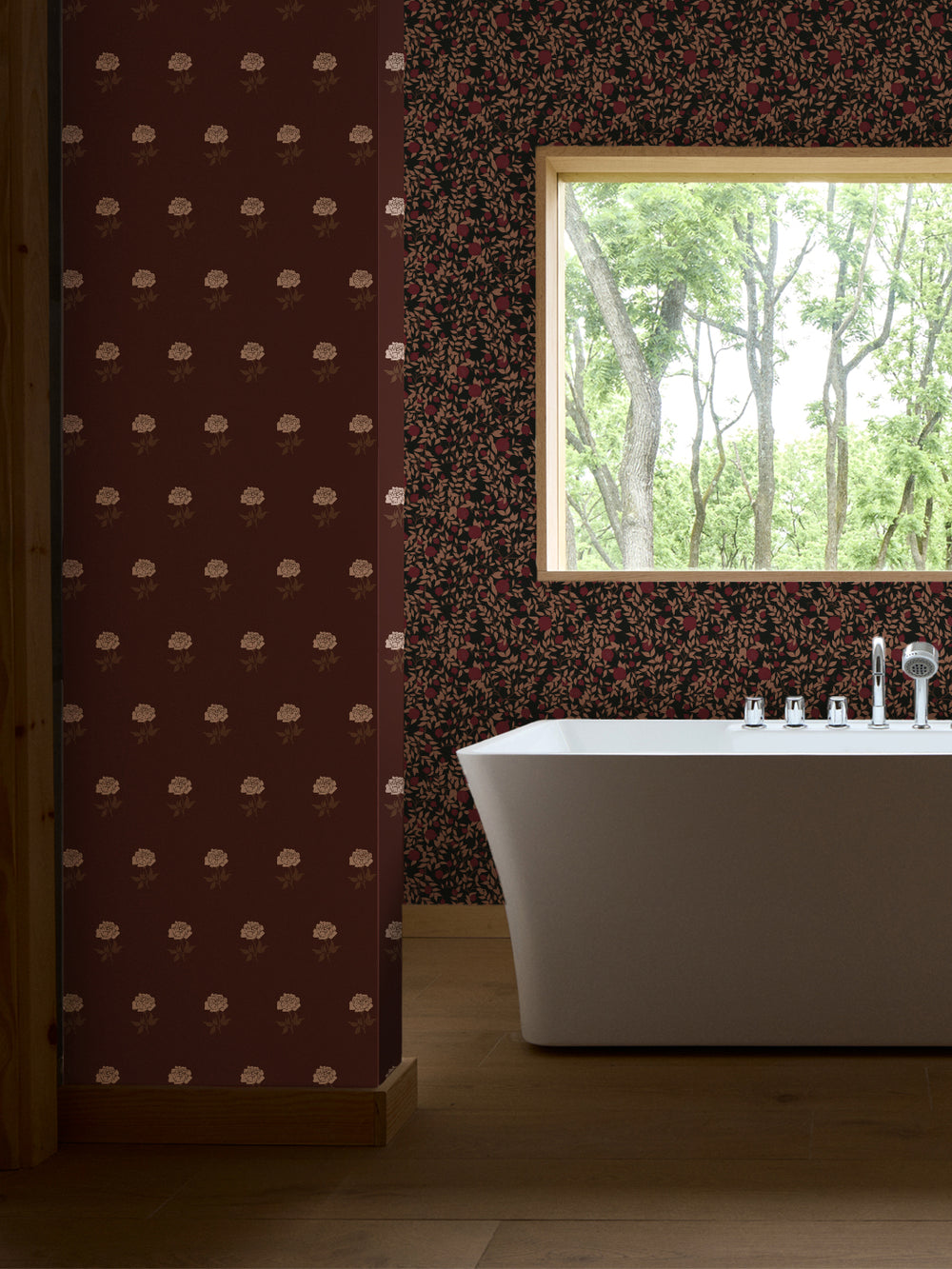 White freestanding tub and chrome faucet by a window, black pomegranate paper beside a burgundy rose wall