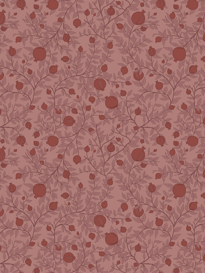 Tonal pomegranate branch wallpaper with oxblood fruit and rose leaves on a dusty pink ground