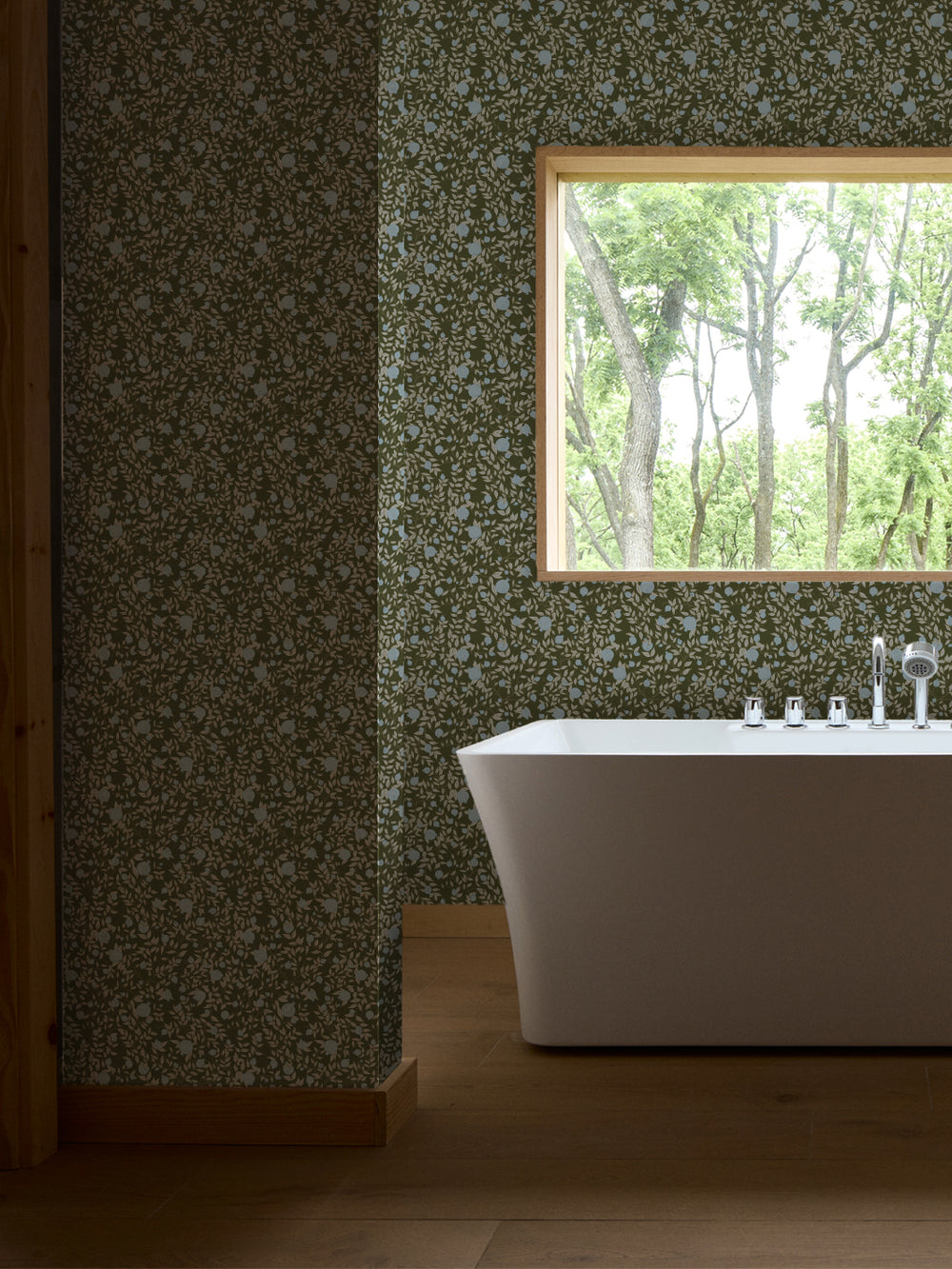 White freestanding tub and chrome faucet by a window, walls in olive and blue pomegranate paper