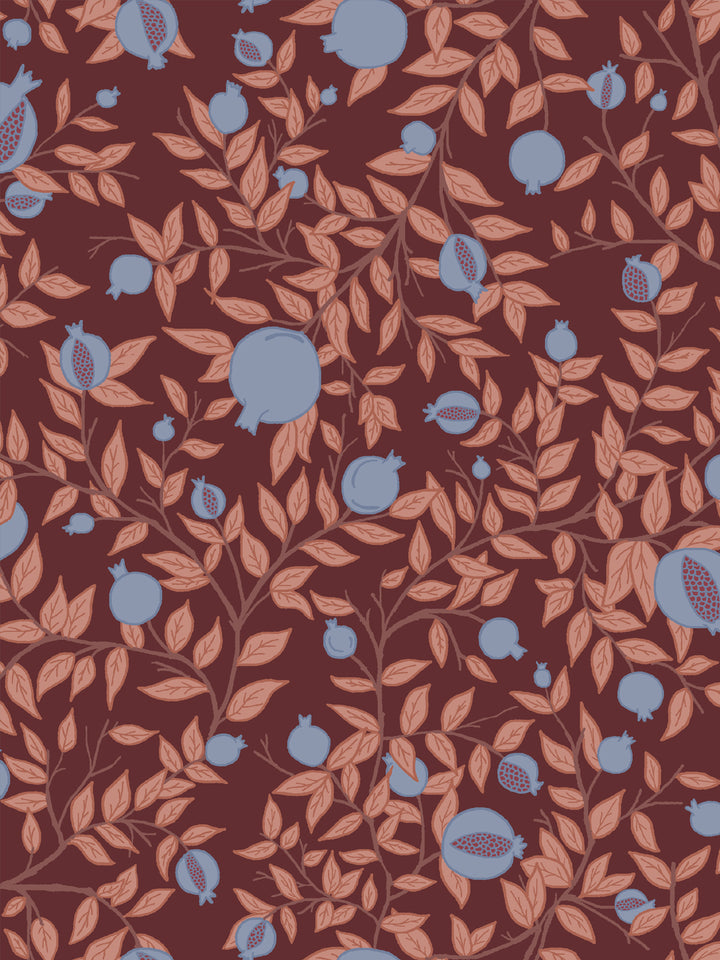 Close crop of periwinkle blue-grey pomegranate fruit on deep plum-burgundy