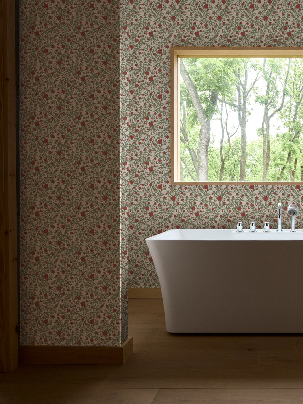 White freestanding tub and chrome faucet by a window, walls in ivory pomegranate paper with red fruit