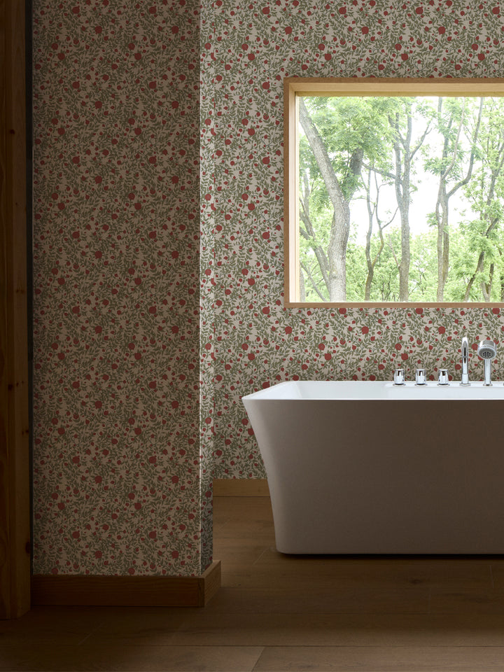 White freestanding tub and chrome faucet by a window, walls in ivory pomegranate paper with red fruit