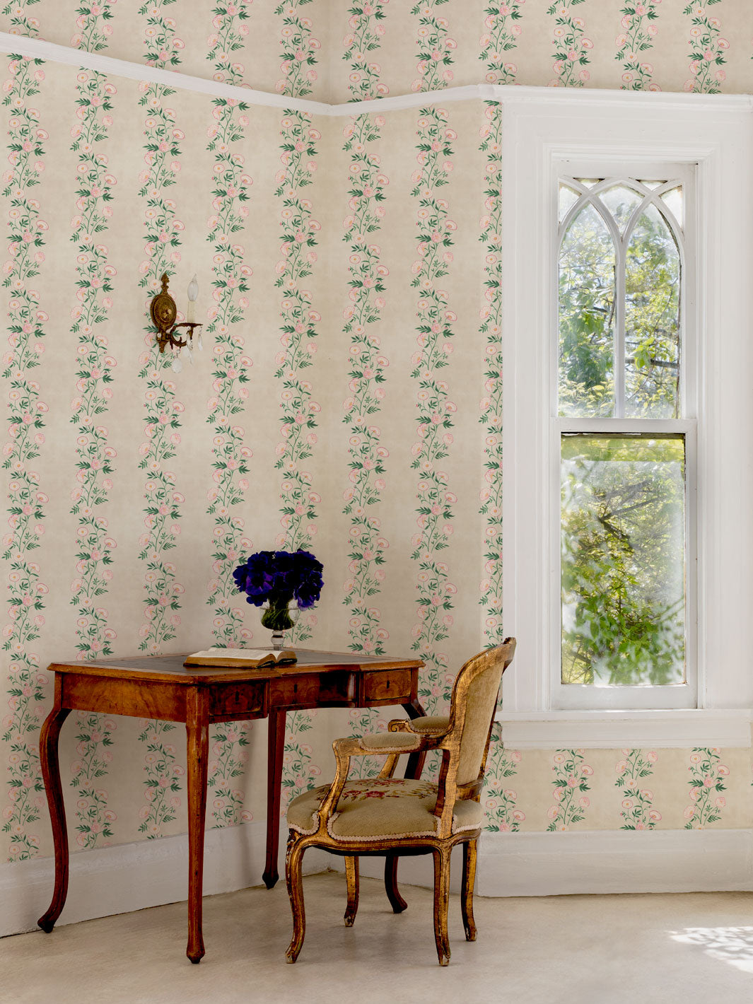 Floral wallpaper with narrow vertical stripe pattern on pale parchment walls