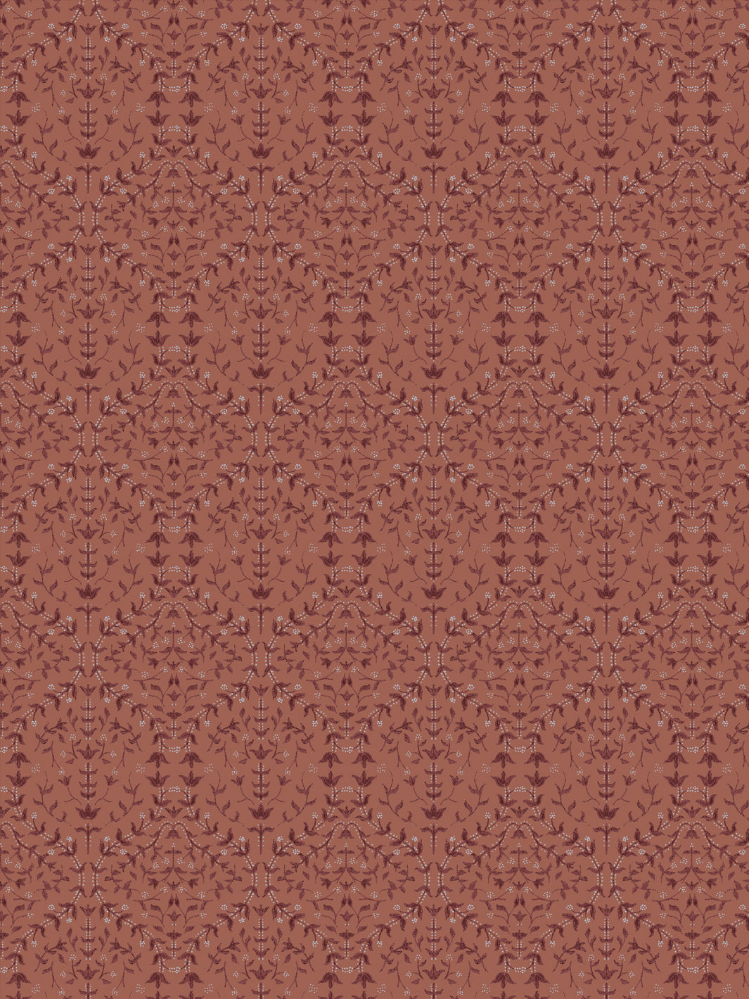 Close crop of deeper maroon-brown lily sprigs on muted terracotta clay