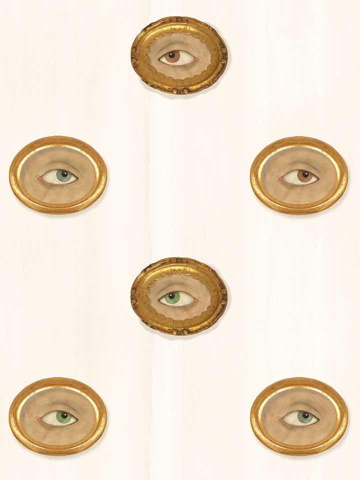 Warm ivory wallpaper with gilt oval frames holding painted eyes in brown, green and blue-gray