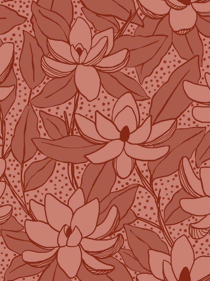 Close crop of muted dusty rose-clay flowers magnolia blooms on dusty terracotta brick