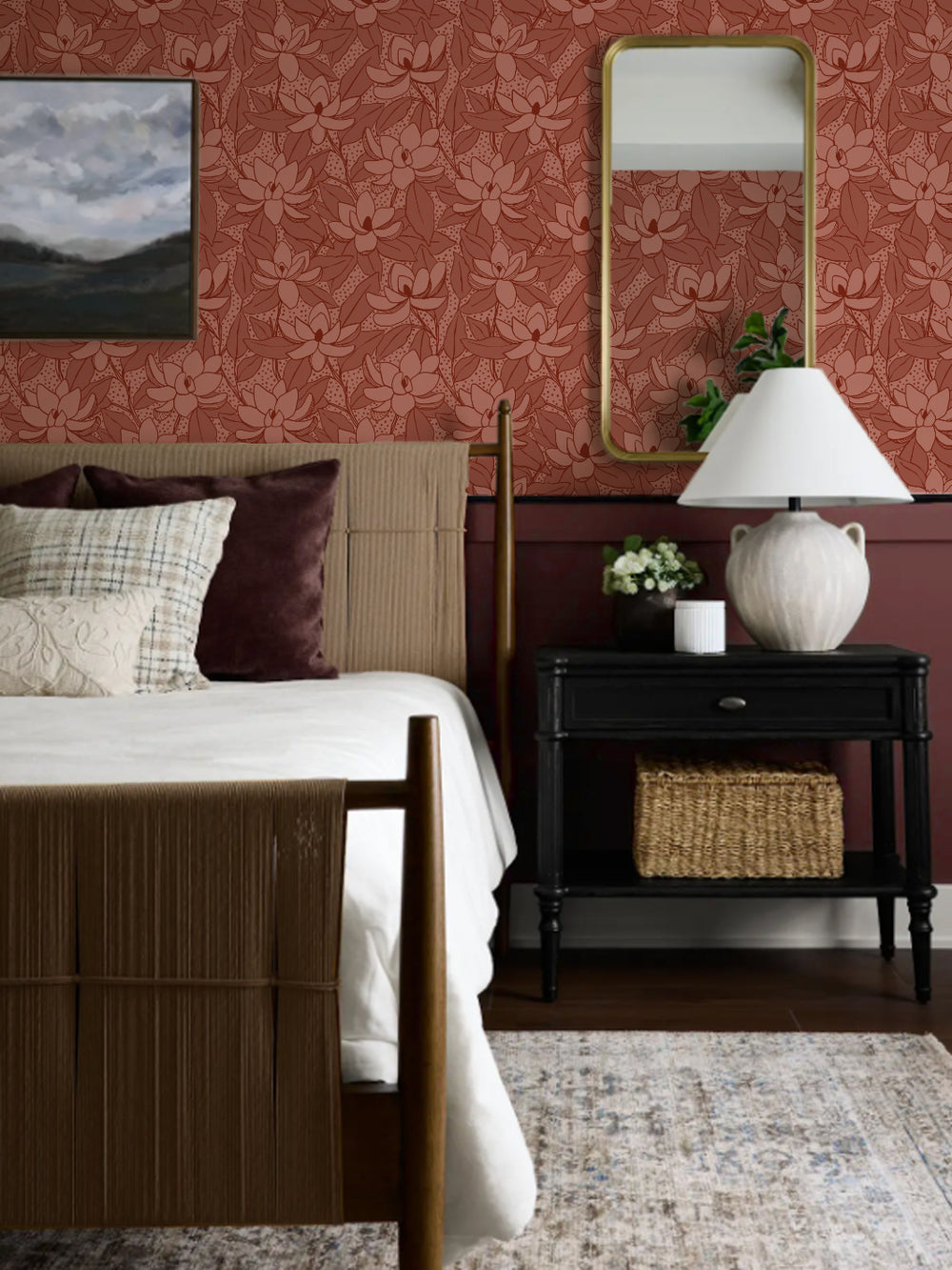 Clay Wash Magnolias wallpaper in a bedroom with woven bed, black nightstand and gold mirror