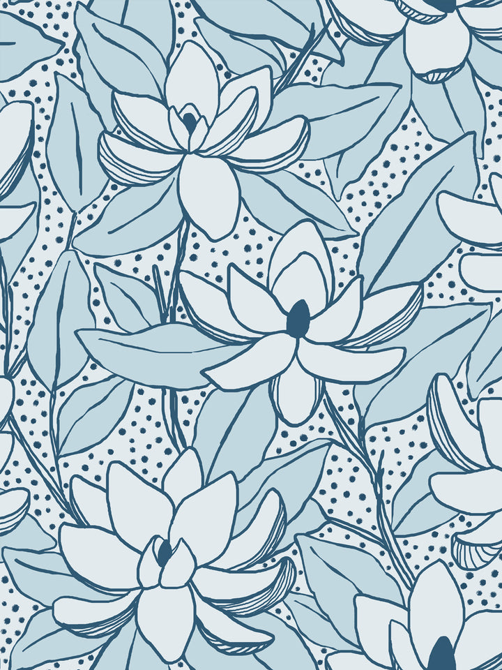 Close crop of near-white pale blue flowers magnolia blooms on very pale ice blue