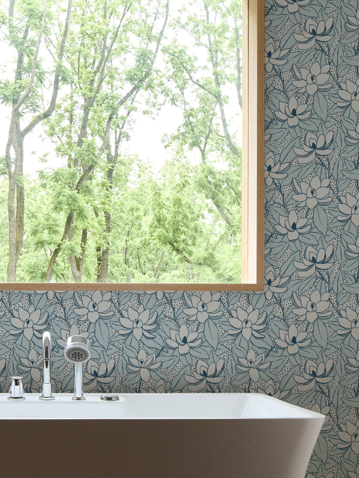 Glacier Navy Magnolias wallpaper in a bathroom with white freestanding tub and oak-framed window