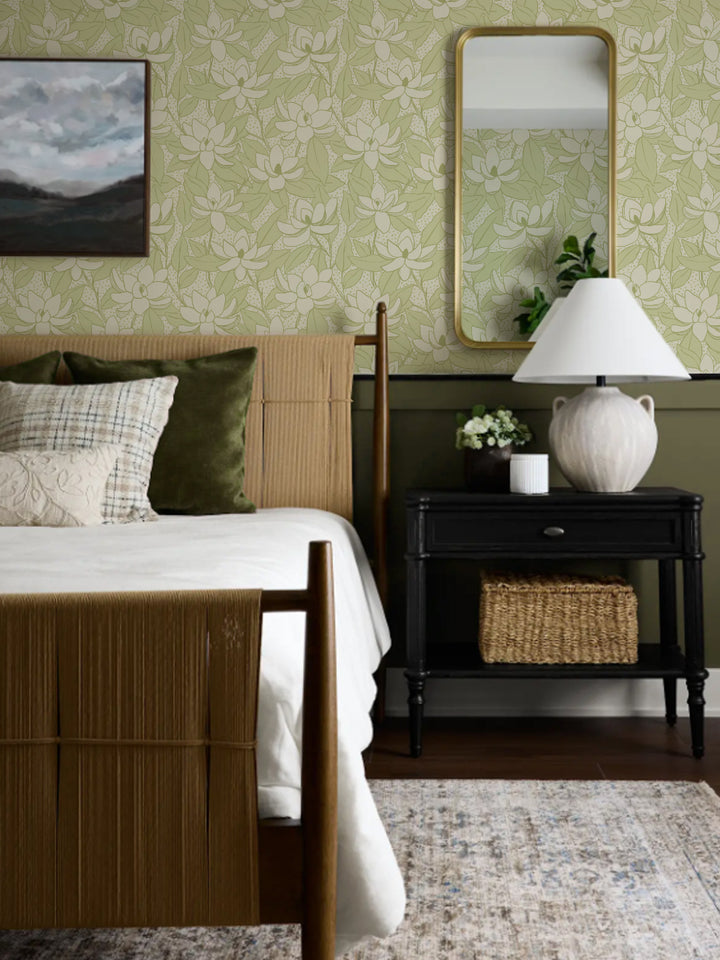Limoncello Magnolias wallpaper above olive wainscot in a bedroom with rush bed and gold mirror