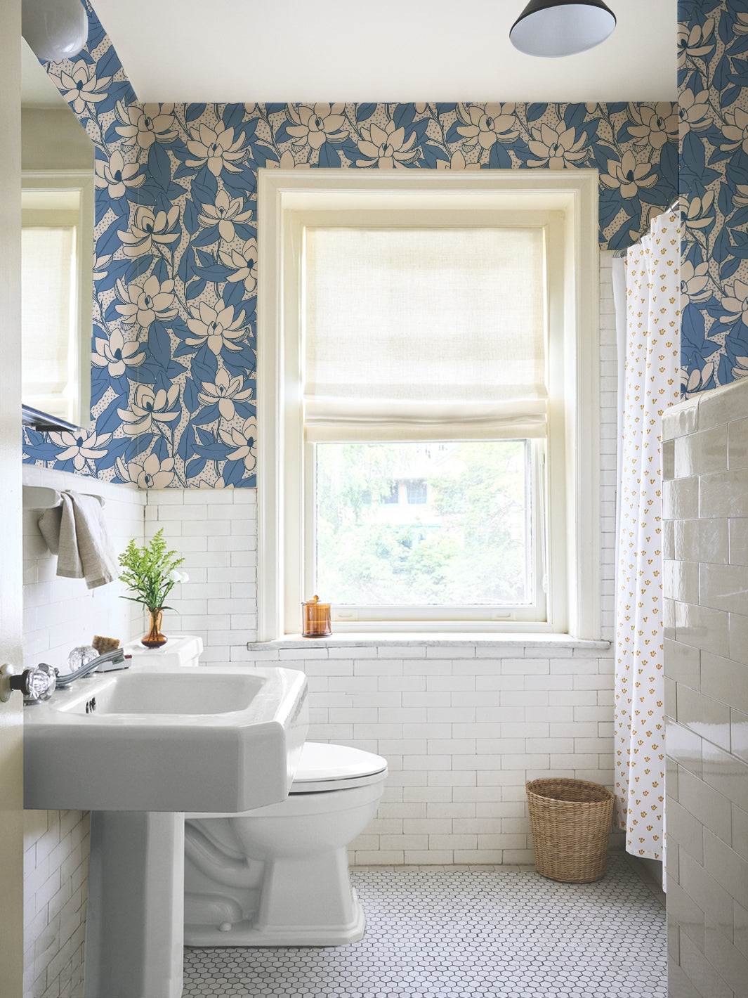 Linen Cornflower Magnolias wallpaper in a tiled bathroom with pedestal sink and roman shade