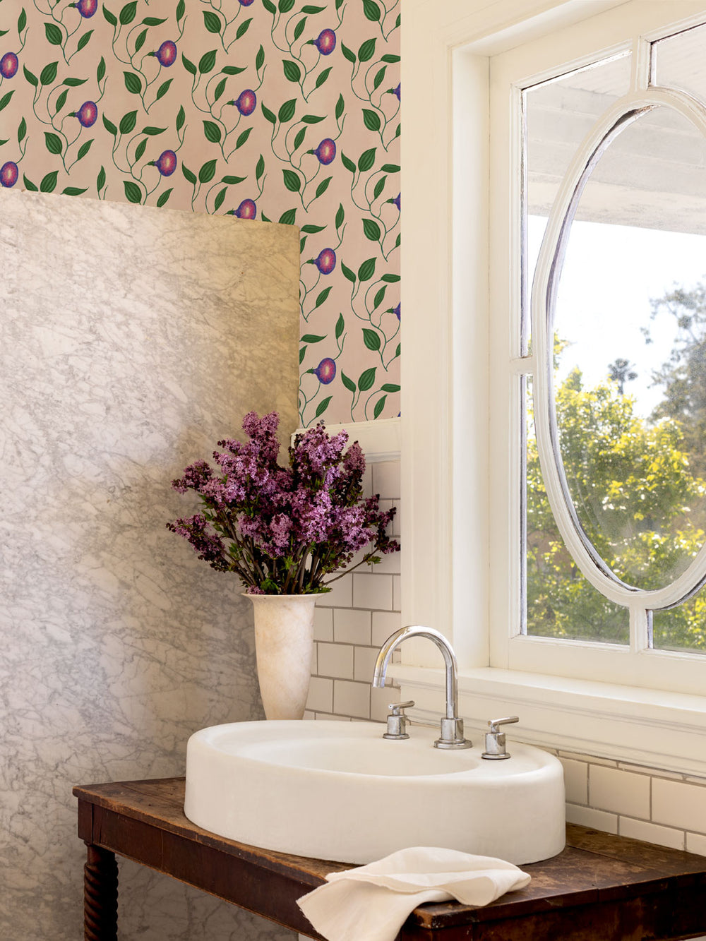 Blush botanical wallpaper with leafy vines and purple morning glory flowers in bathroom