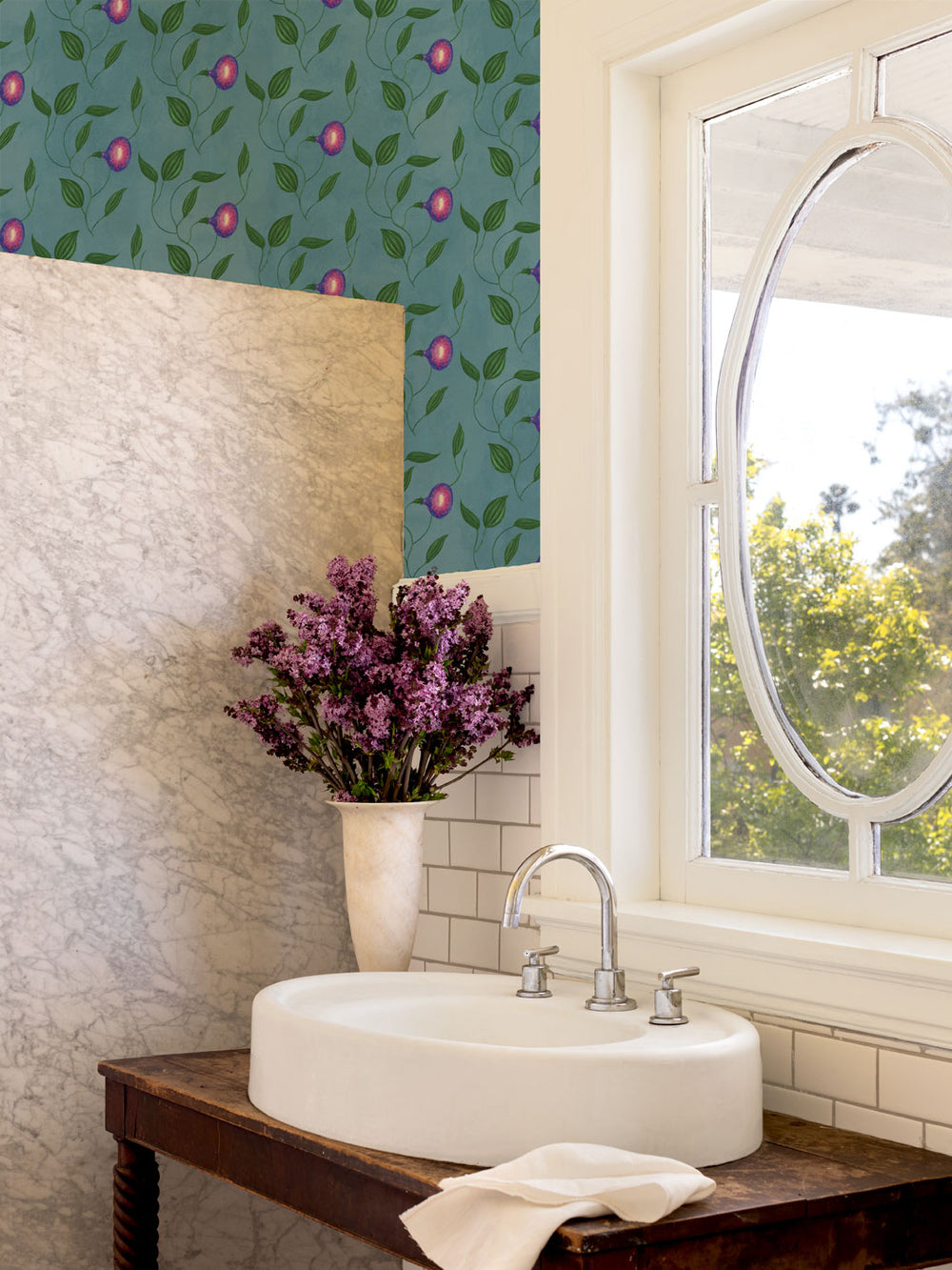Floral leaf and berry wallpaper on a bathroom wall above a sink