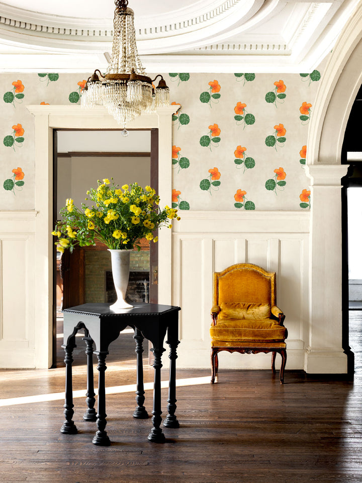 Wallcovering wallpaper with orange flowers and green leaves in a room setting