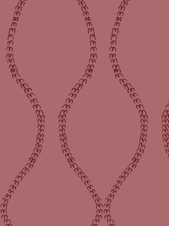 Close crop of deep garnet wine red a leaf-chain trellis on dusty rose
