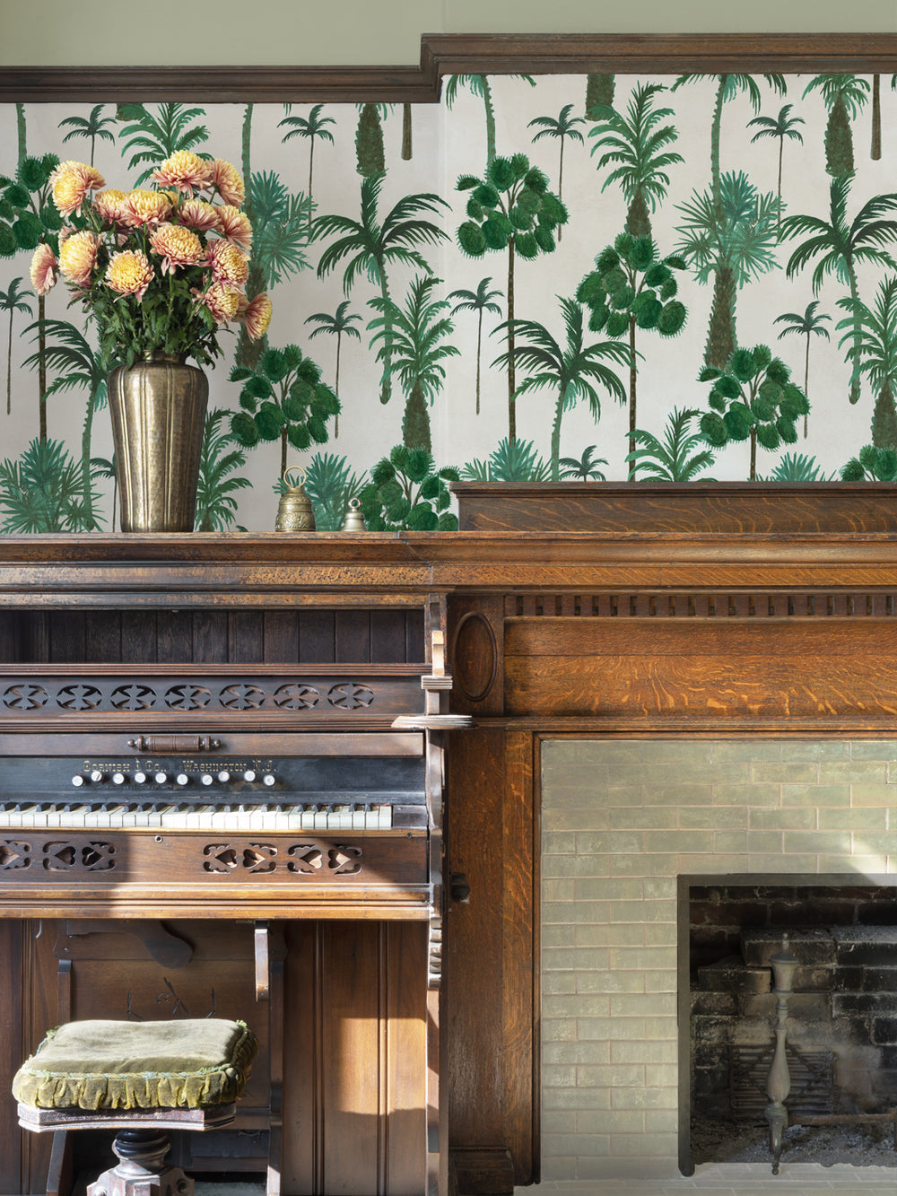 Palm forest wallpaper on wall with green palm trees above a fireplace
