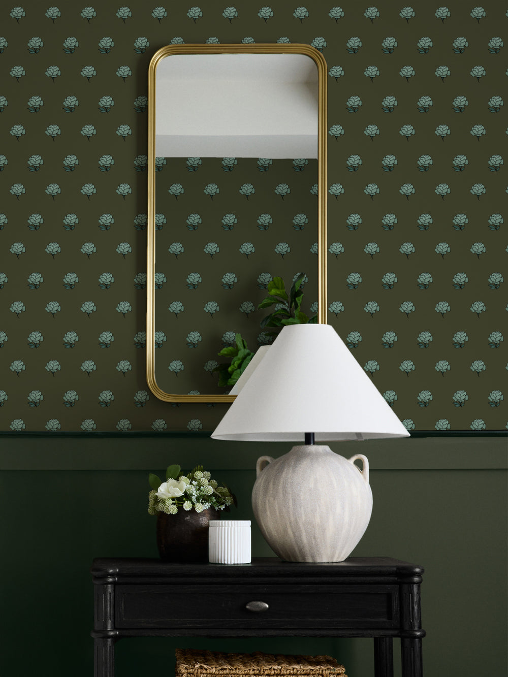 Entry wall in teal on olive peony wallpaper with a gold mirror, ceramic lamp and black console