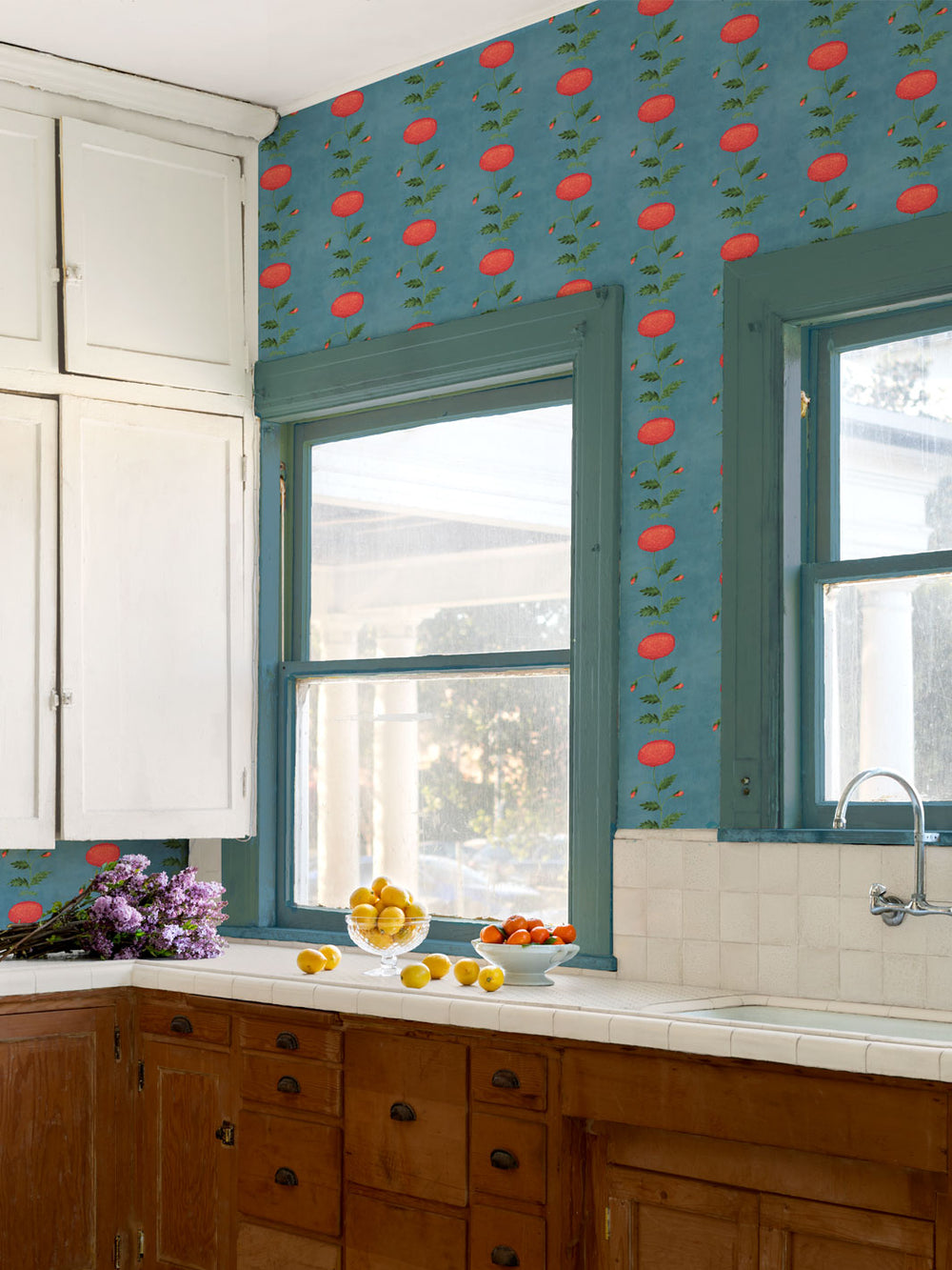 Floral wallpaper on kitchen wall with red persimmon pattern and green leaves