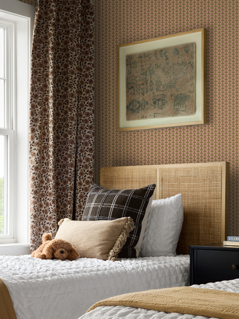 Peach Pomara Bloom wallpaper in a bedroom with a cane headboard, floral curtain and plaid pillow