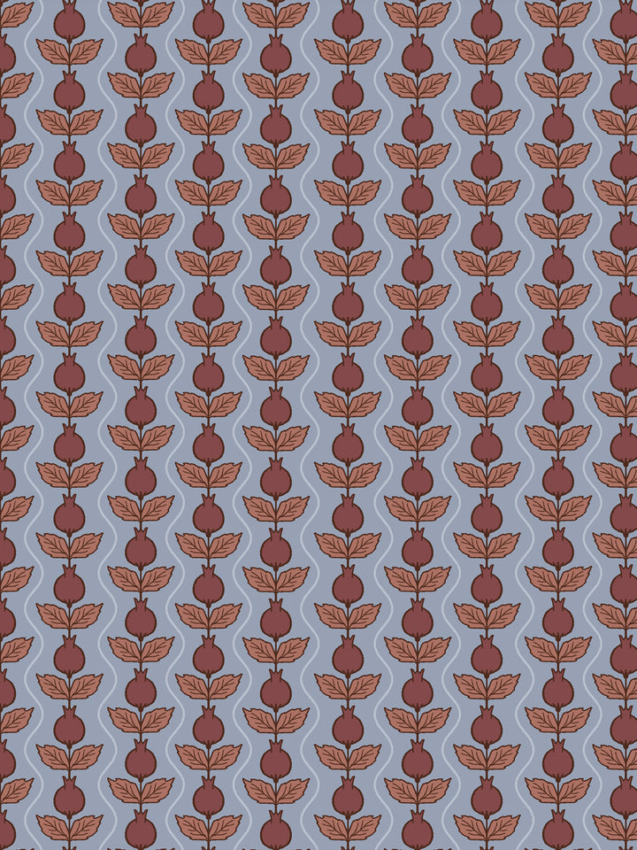 Close crop of deep maroon-oxblood pomegranate columns on dusty slate blue